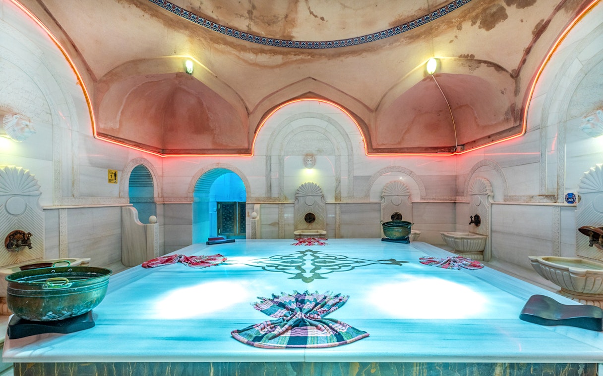 Acemoglu Hamam interior with marble platform and traditional decor, 15th-century Turkish bath.