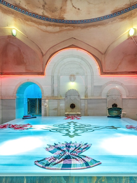 Acemoglu Hamam interior with marble platform and traditional decor, 15th-century Turkish bath.