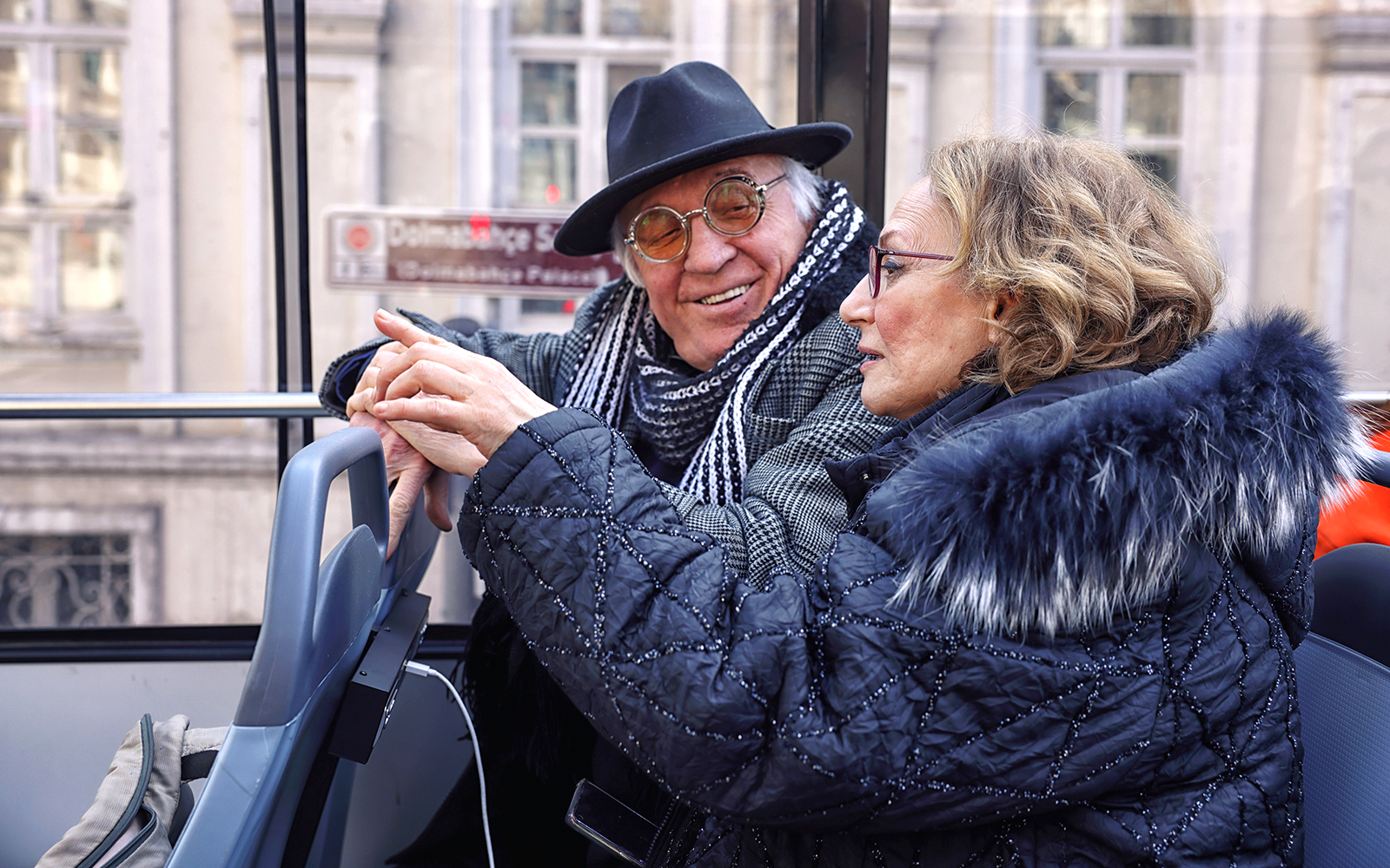 Elderly couple enjoying Istanbul hop-on hop-off bus tour.