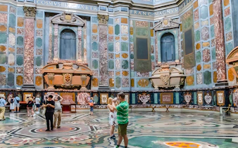 Visitors exploring the ornate interior of the Medici Chapels in Florence, Italy.