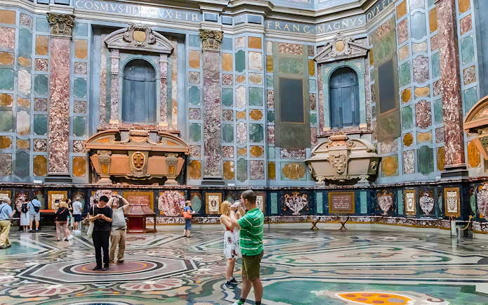 Visitors exploring the ornate interior of the Medici Chapels in Florence, Italy.