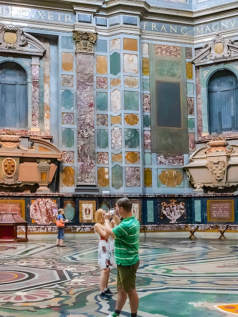 Visitors exploring the ornate interior of the Medici Chapels in Florence, Italy.