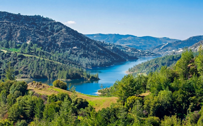 Kannaviou Dam surrounded by lush greenery in the Troodos Mountains, Cyprus.