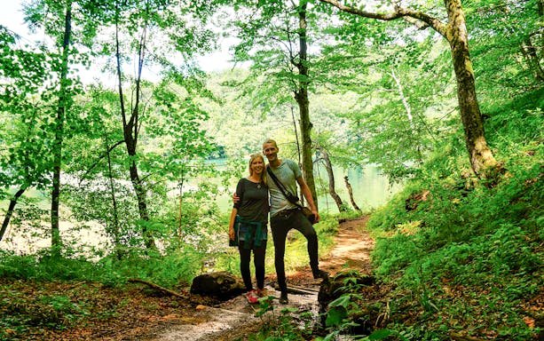 Visitors exploring forest trails near Plitvice Lakes, Croatia.
