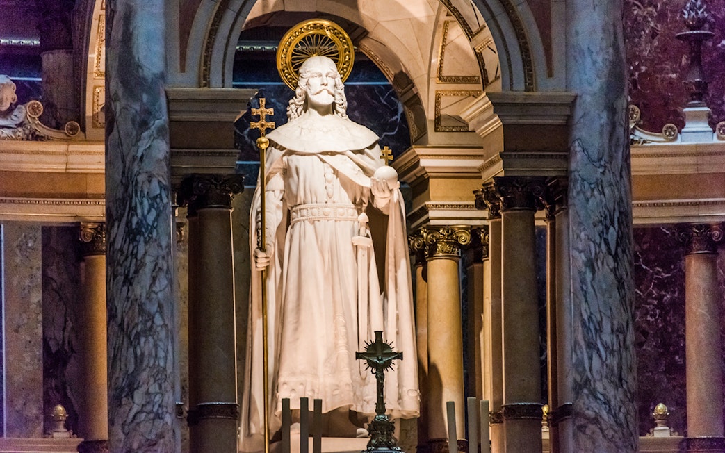 Statue at the altar of St. Stephen's Basilica, Budapest, with ornate columns.