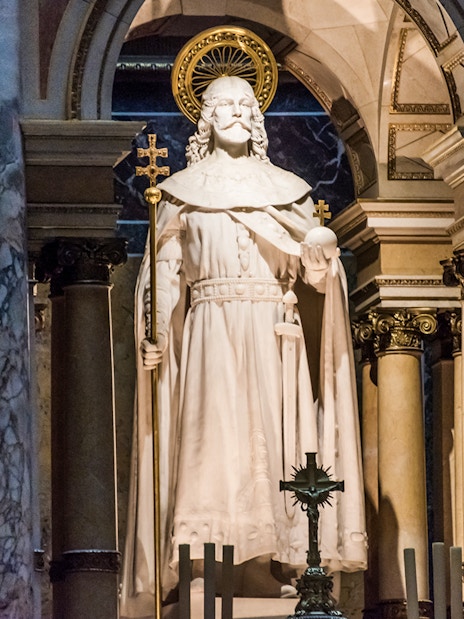 Statue at the altar of St. Stephen's Basilica, Budapest, with ornate columns.