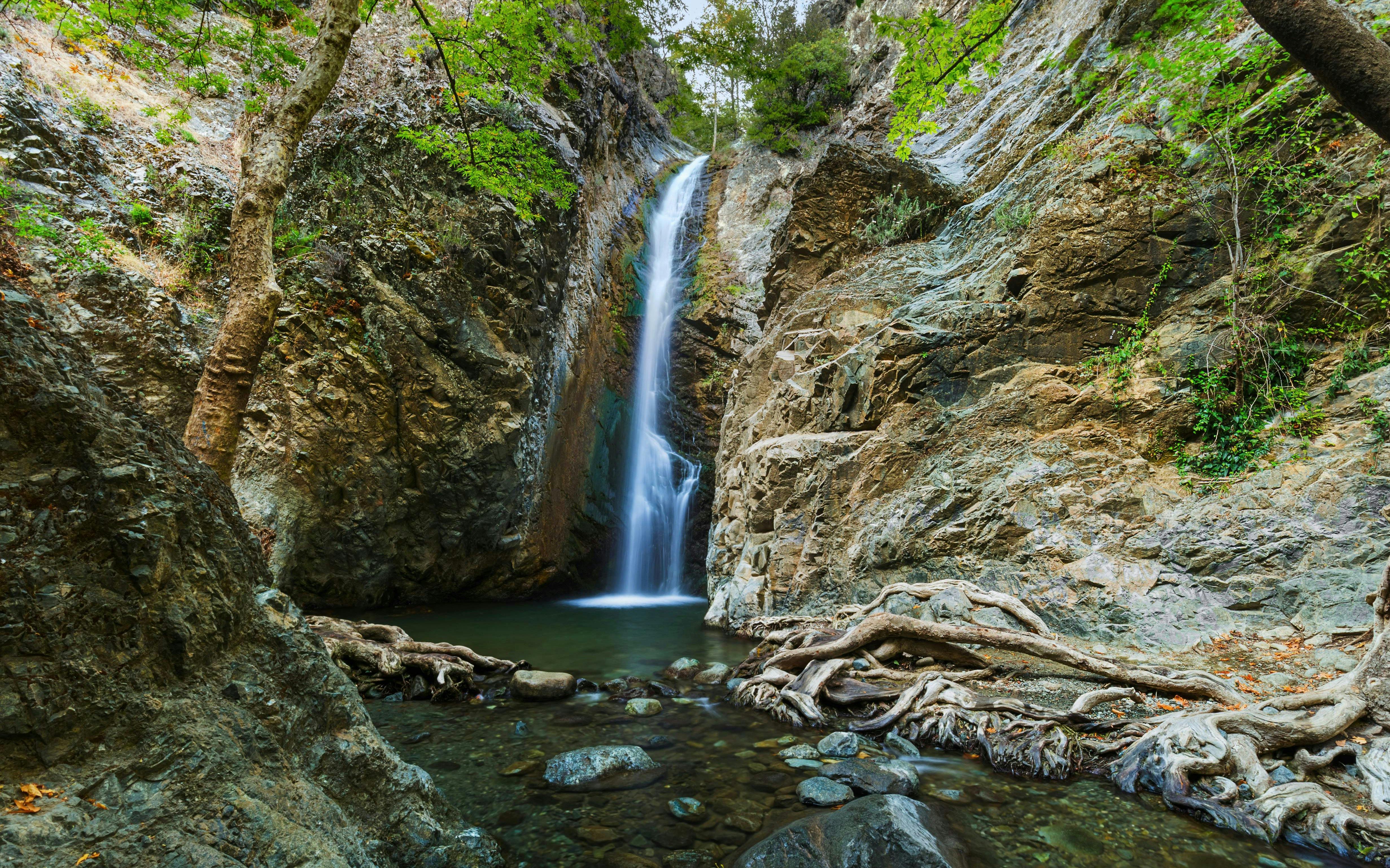 Millomeris Waterfalls cascading over rocky cliffs in Cyprus.