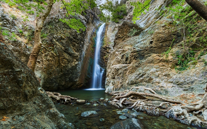 Millomeris Waterfalls cascading over rocky cliffs in Cyprus.