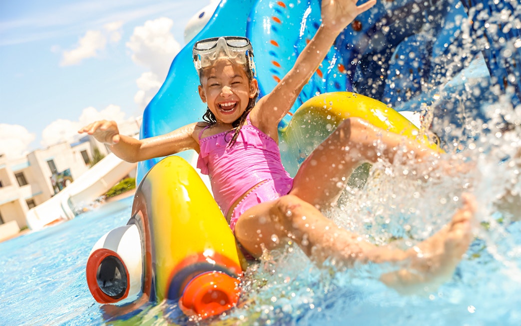 Child enjoying a water slide at Yas Waterworld Abu Dhabi.