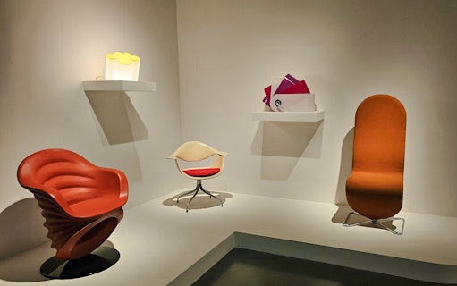 Centre Pompidou Malaga exhibition interior with modern chairs and art displays.