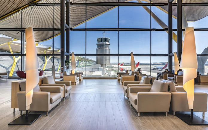 Sala VIP Neptuno lounge seating area with airport view, Adolfo Suarez-Barajas Airport, Madrid.