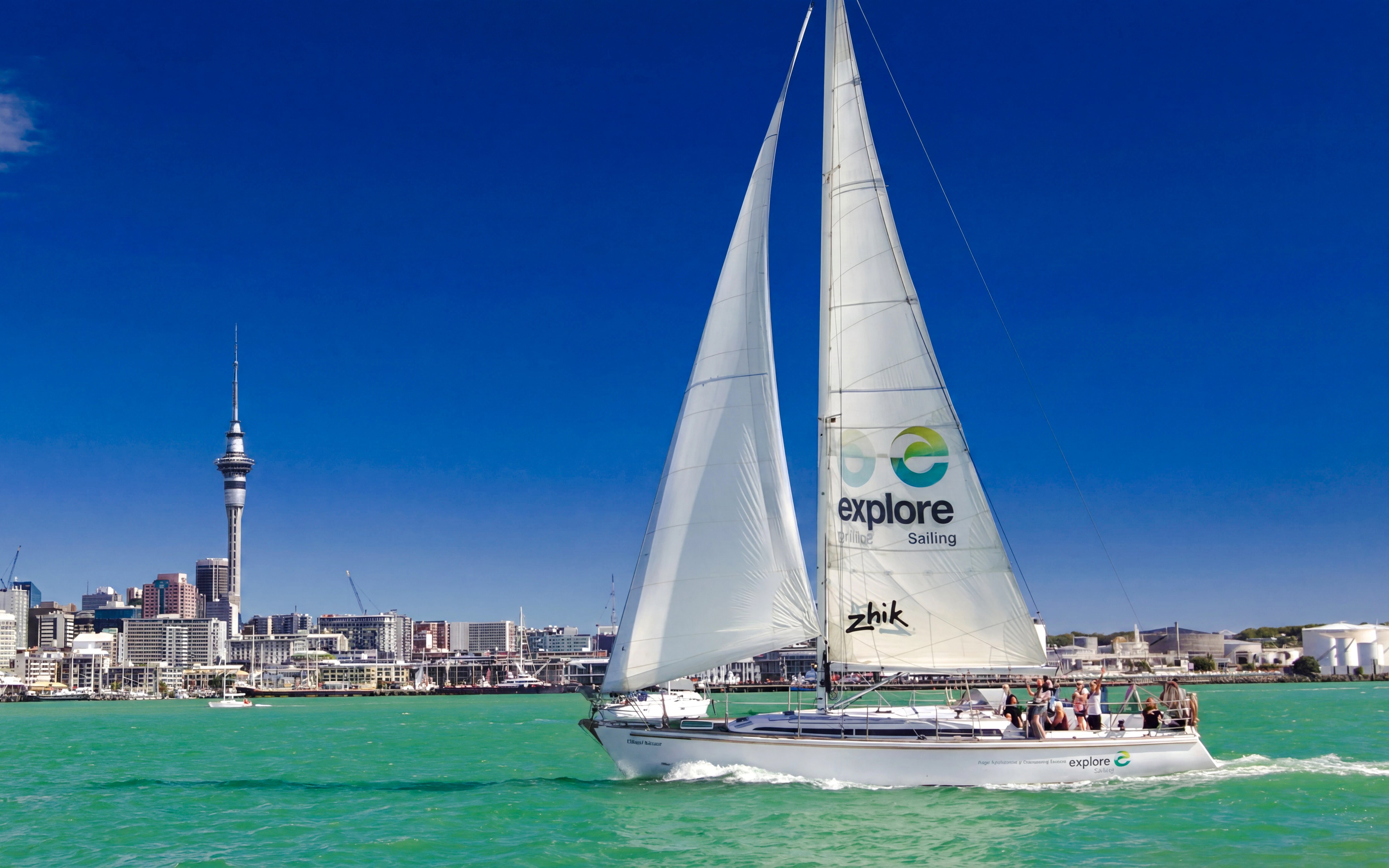 Sailing cruise on Waitematā Harbour with Auckland skyline in the background.