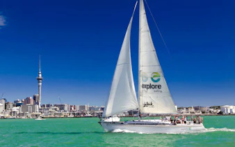 Sailing cruise on Waitematā Harbour with Auckland skyline in the background.