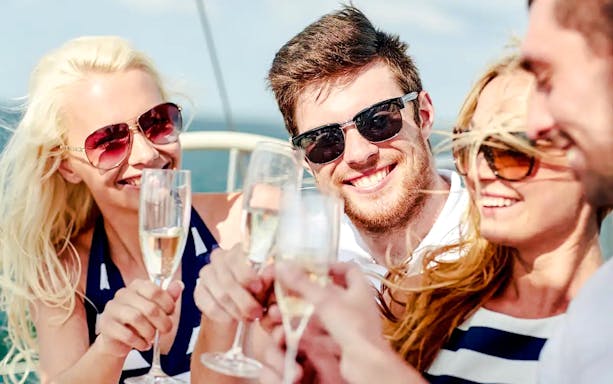 Group enjoying drinks at open bar on cruise.