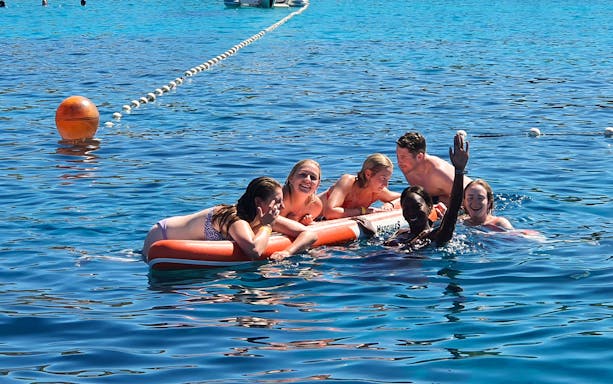 Group enjoying water activities during yacht sail in Hvar.