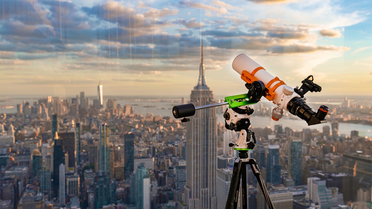 Visitors stargazing through telescopes at Summit One Vanderbilt's observation deck in New York City.