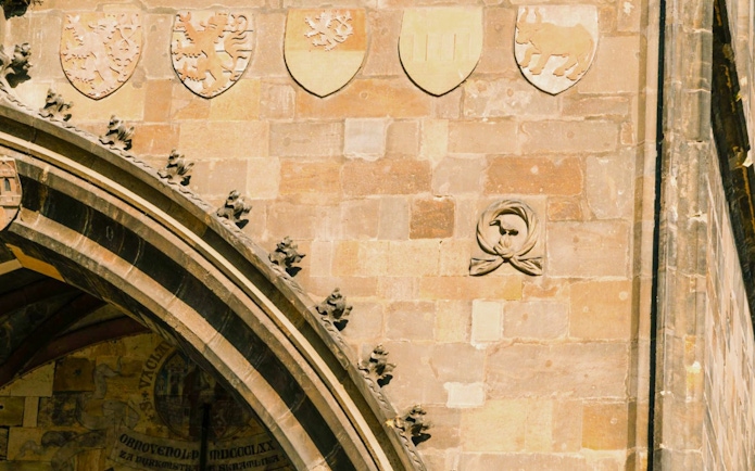 Old Town Bridge Tower stone carvings and coat of arms details.