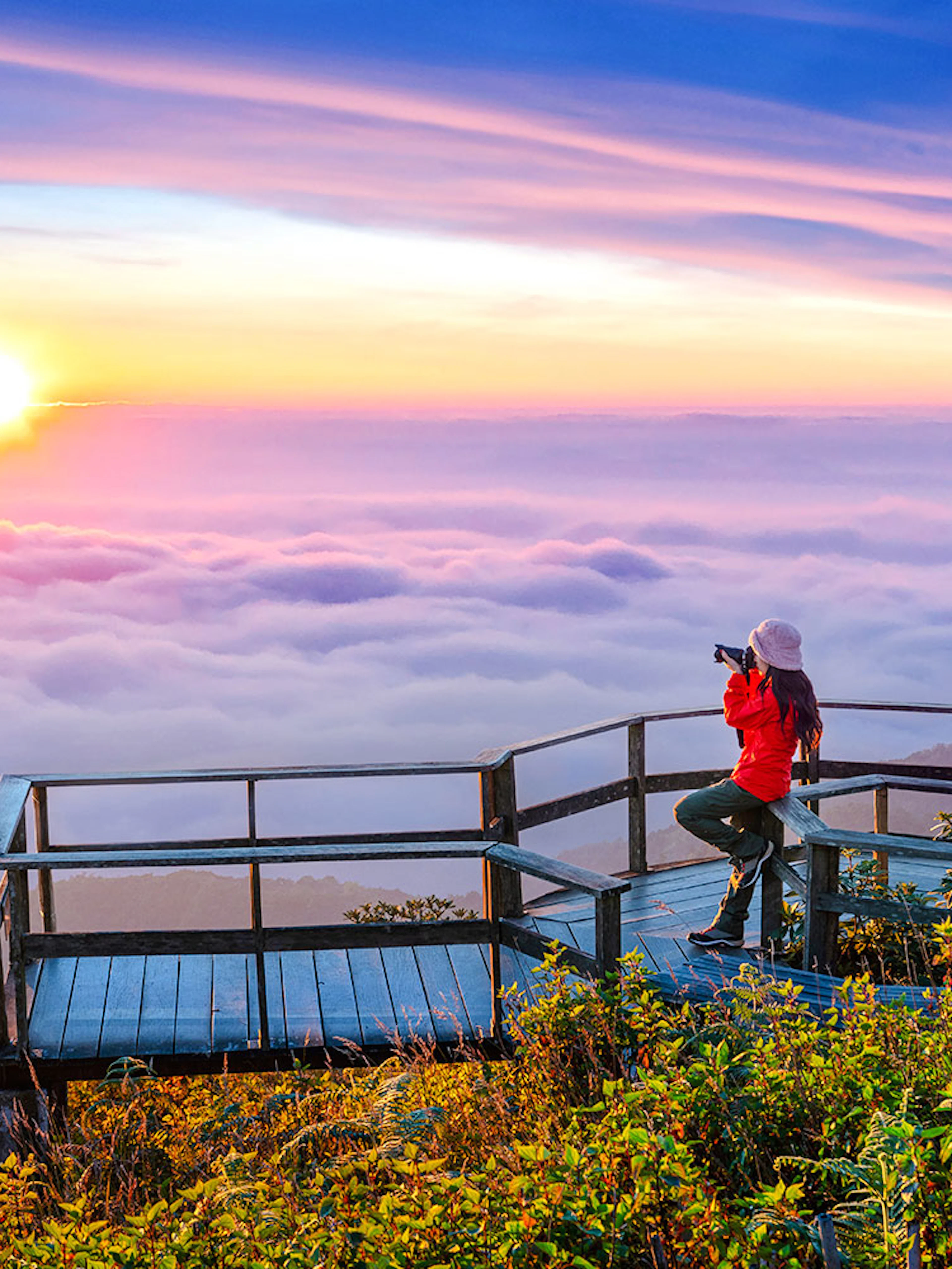 Tourist photographing sunset at Kew Mae Pan viewpoint, Doi Inthanon, Chiang Mai, Thailand.