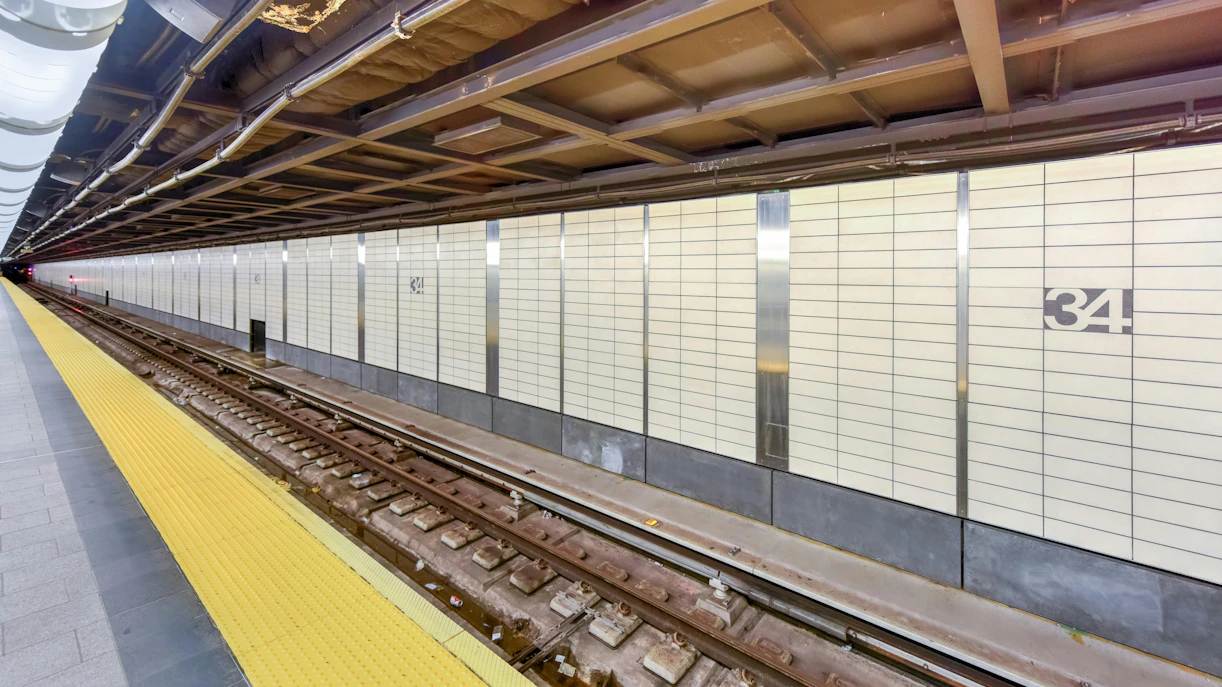 Hudson Yards Subway Station platform in Chelsea, NYC, with tracks and tiled walls.