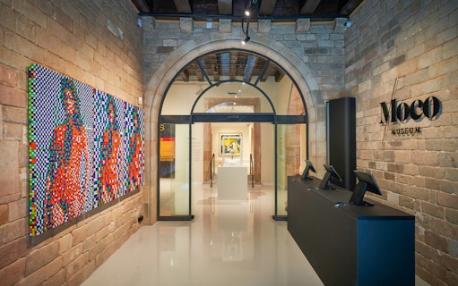 Moco Museum entrance in Barcelona with colorful modern art display.