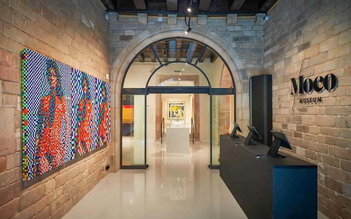 Moco Museum entrance in Barcelona with colorful modern art display.