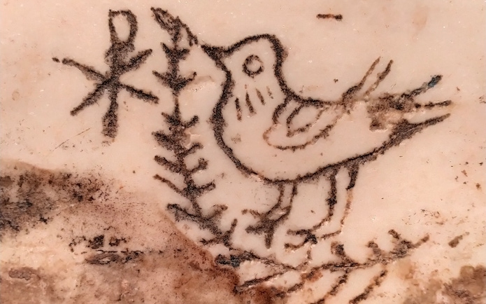 Ancient bird carving in Catacombs of Saint Agnes, Rome.