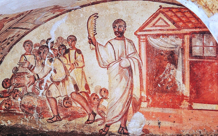 Ancient fresco depicting figures in Roman attire inside catacombs on the Appian Way, Rome.