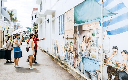 Tour group exploring mural art in Singapore's cultural district.
