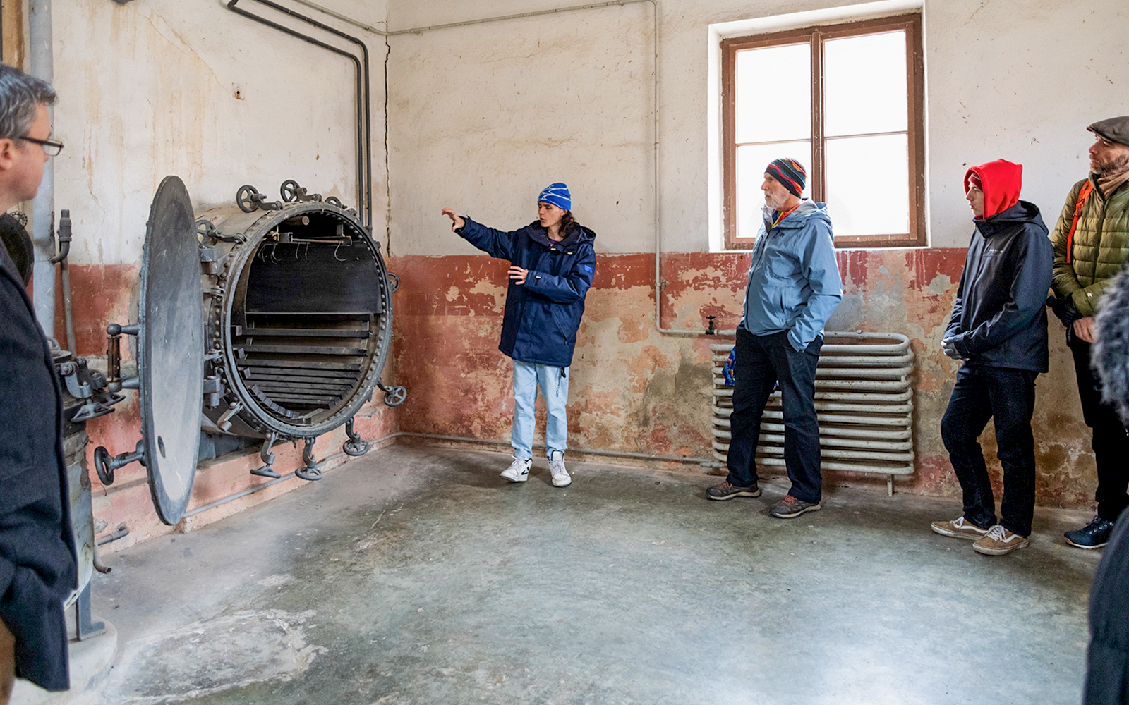 Guide explaining historical details to tourists at Terezin Concentration Camp.