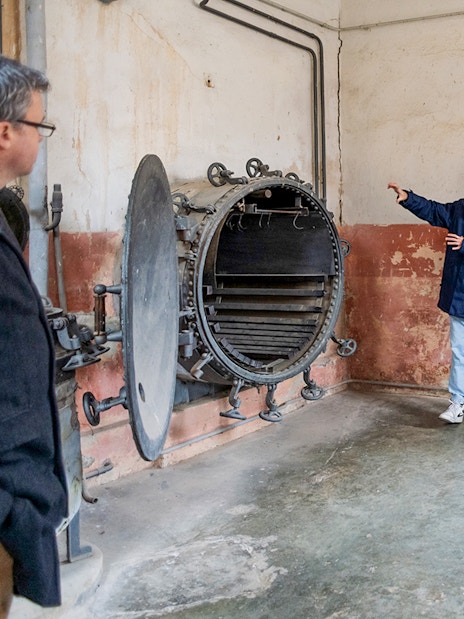 Guide explaining historical details to tourists at Terezin Concentration Camp.