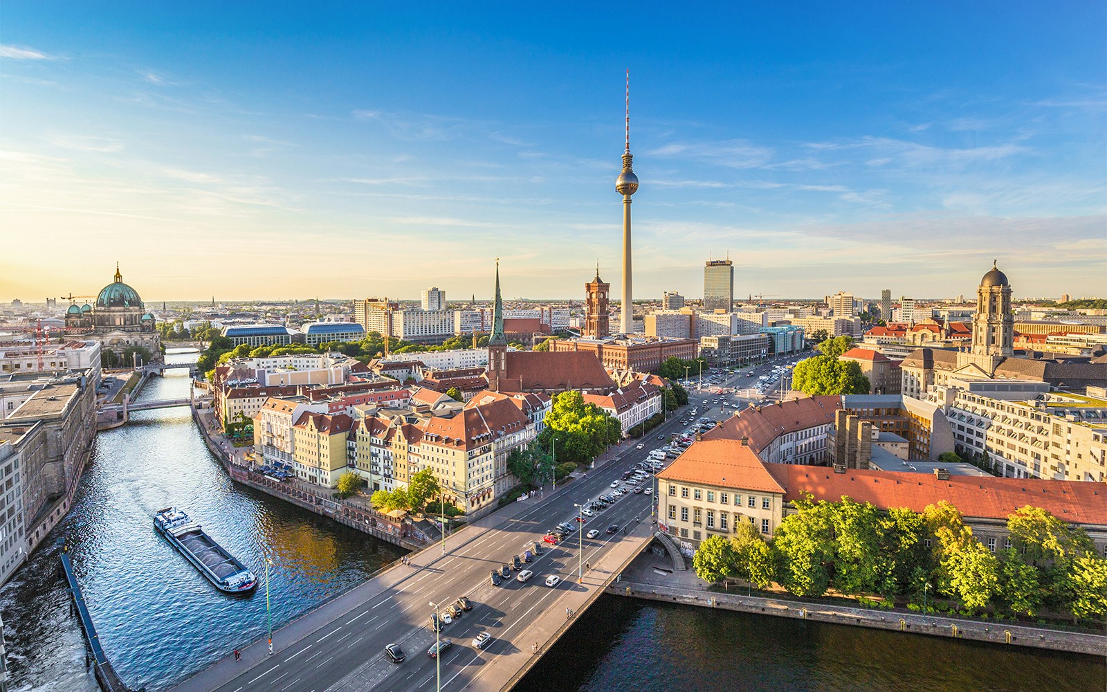 Berlin skyline with TV tower and Spree river at sunset.