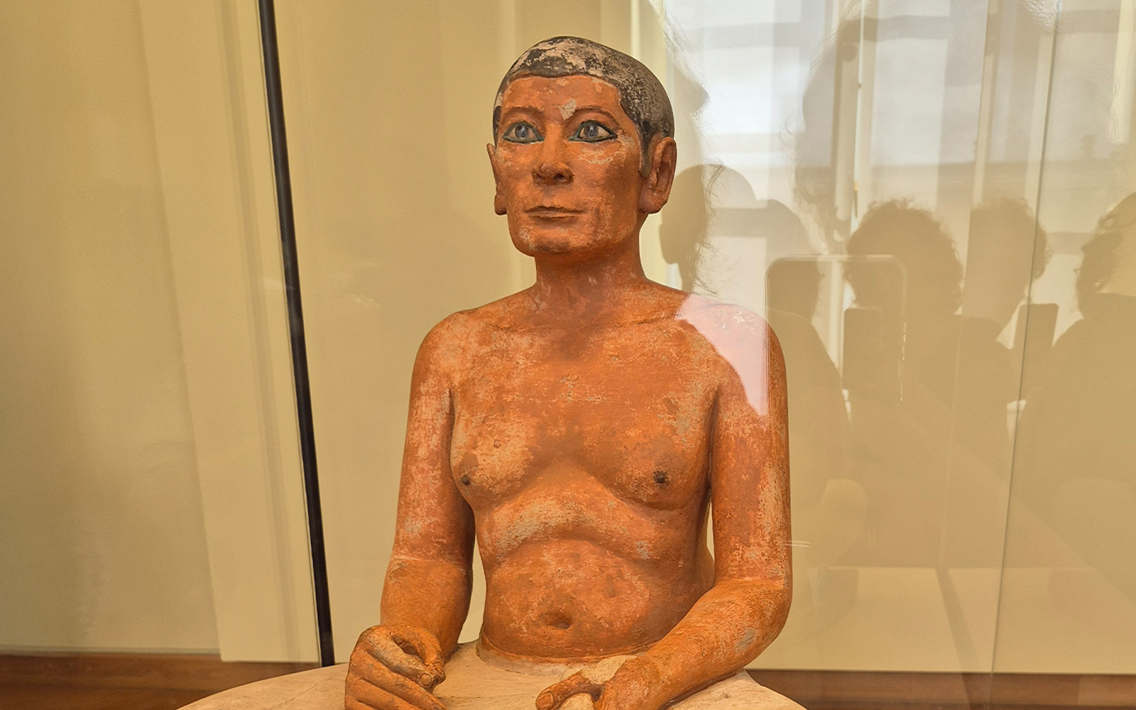 Seated Scribe sculpture in Louvre Museum Egyptian Collection, Paris.