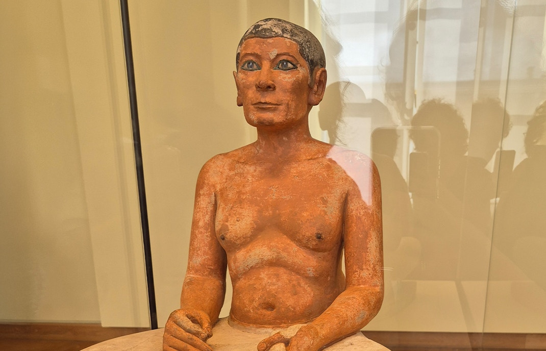 Seated Scribe sculpture in Louvre Museum Egyptian Collection, Paris.