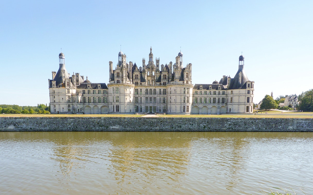 Château de Chambord viewed from across the water on an e-bike tour.