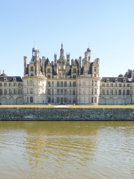 Château de Chambord viewed from across the water on an e-bike tour.
