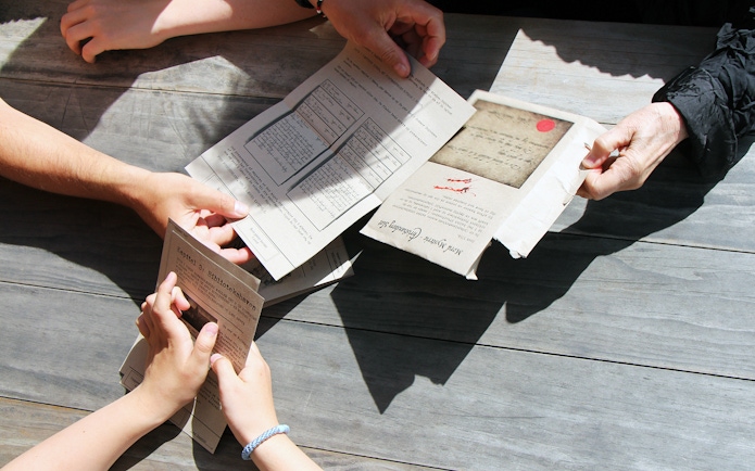 Participants examining mystery hunt clues at Amalienborg Palace.