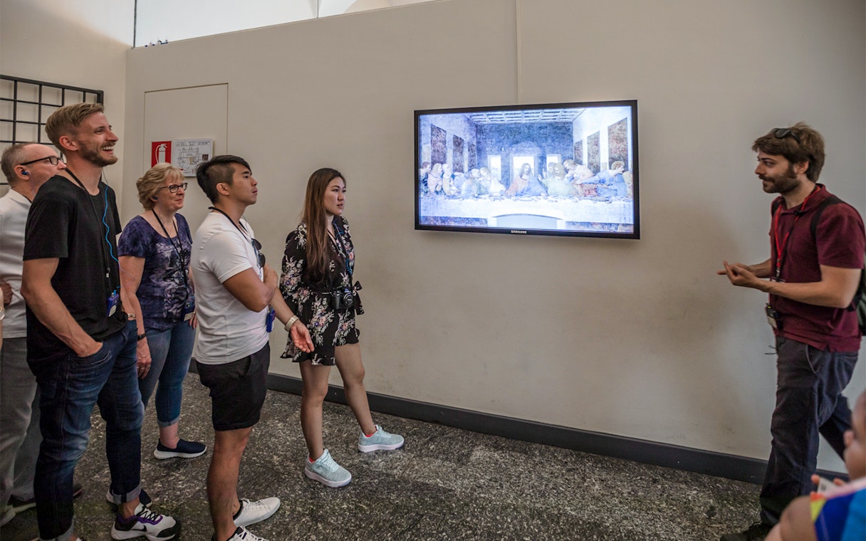 Tour group viewing The Last Supper painting by Leonardo da Vinci in Milan, Italy.