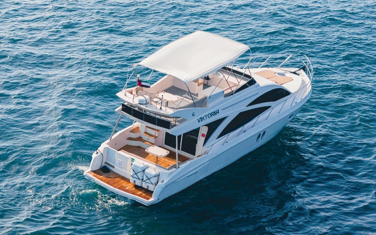 Private luxury yacht sailing in Dubai waters, 46 ft vessel.