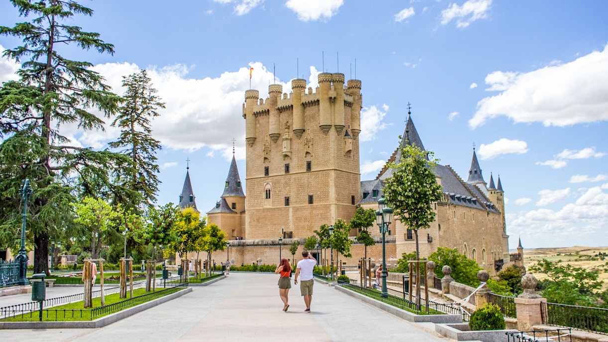 Tourists walking towards the Alcazar of Segovia, Spain.