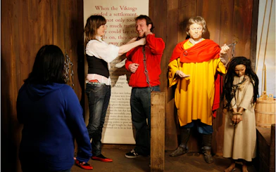 Viking exhibit interaction at Dublin museum with visitors and historical figures.