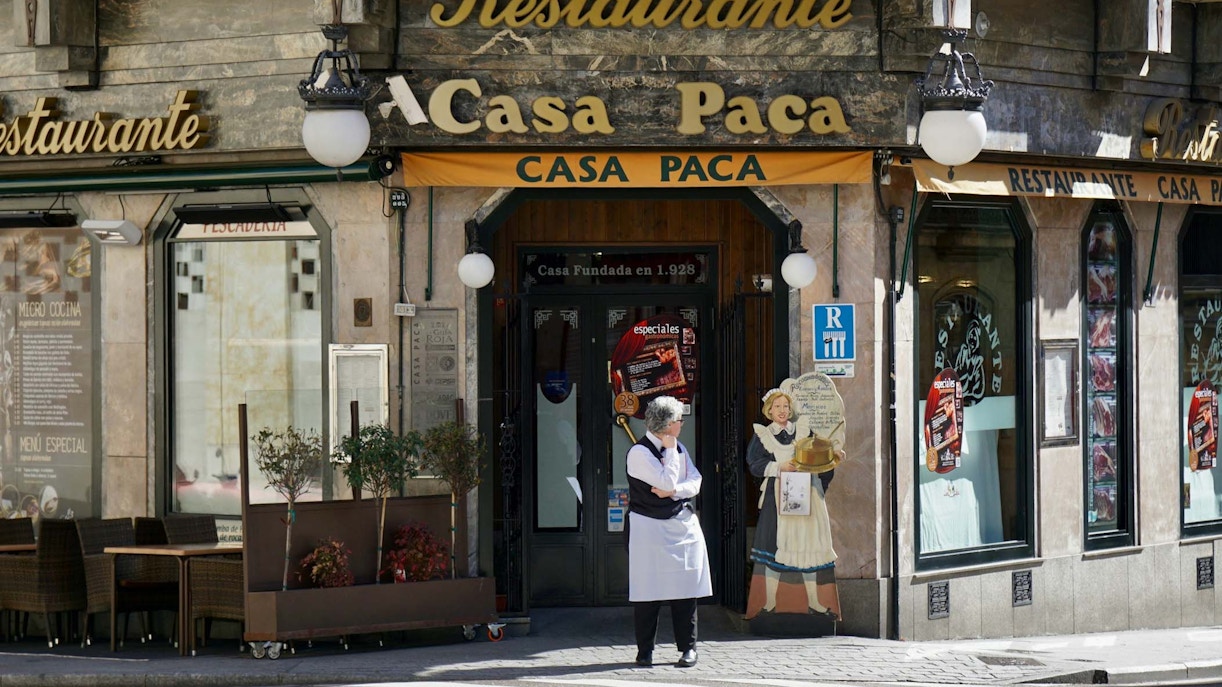 Casa Paca restaurant entrance at Salamanca Place with a staff member outside.