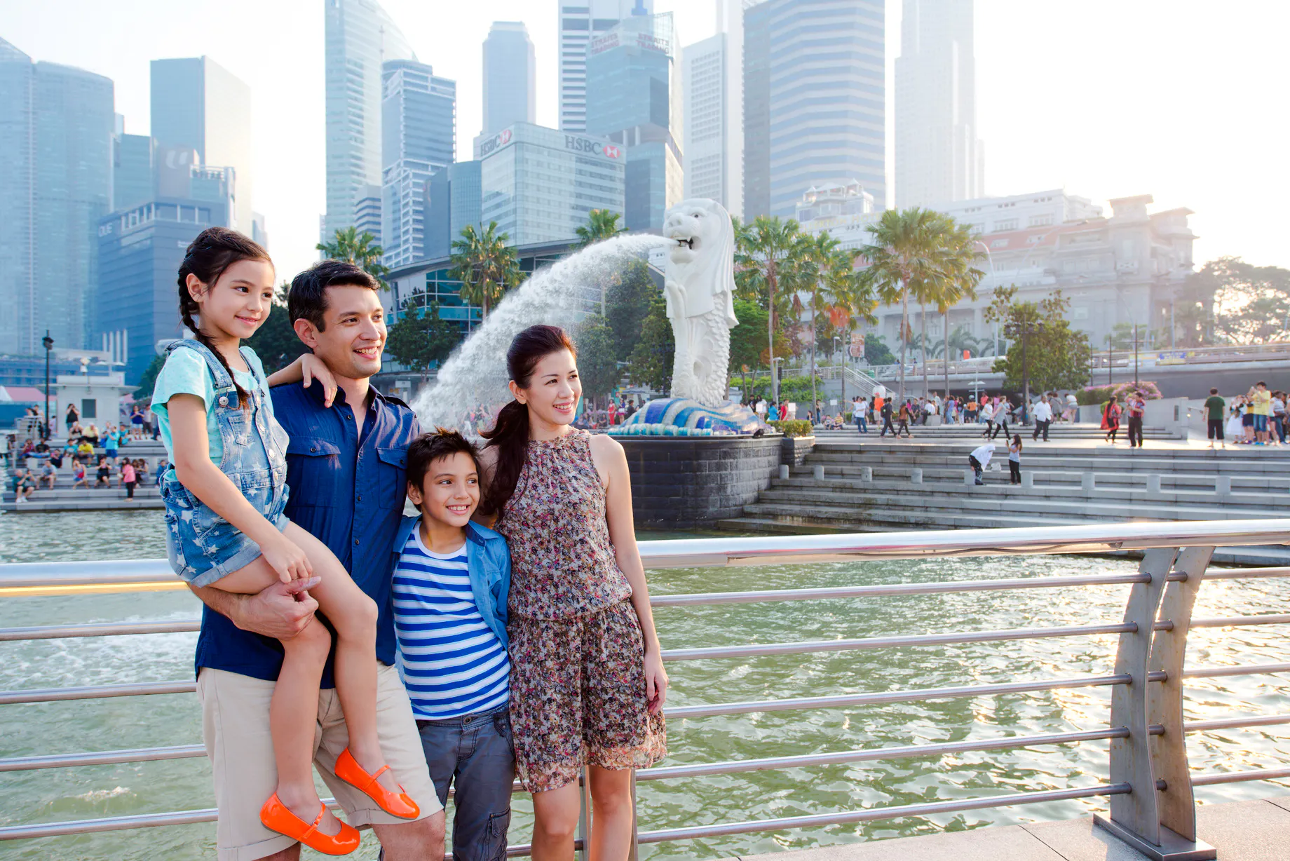 Family enjoying the view of the Merlion statue during a Singapore city tour.