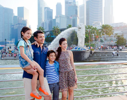 Family enjoying the view of the Merlion statue during a Singapore city tour.