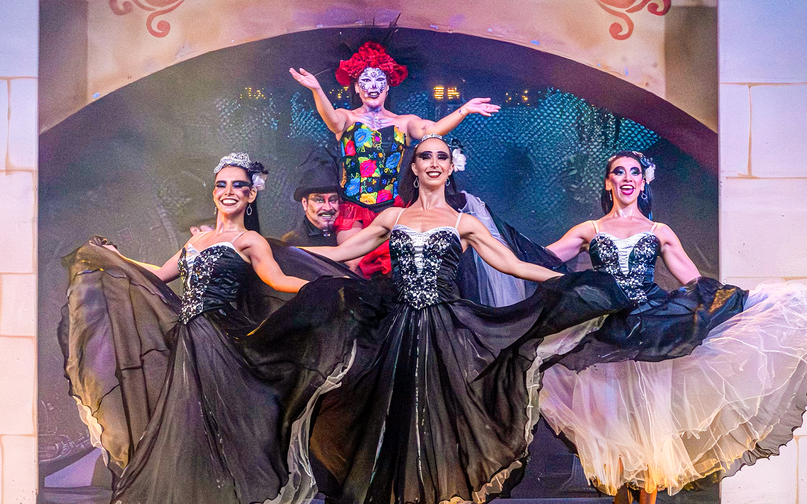 Performers in traditional Mexican attire dancing at Port Aventura's El Día de los Muertos show, Spain.