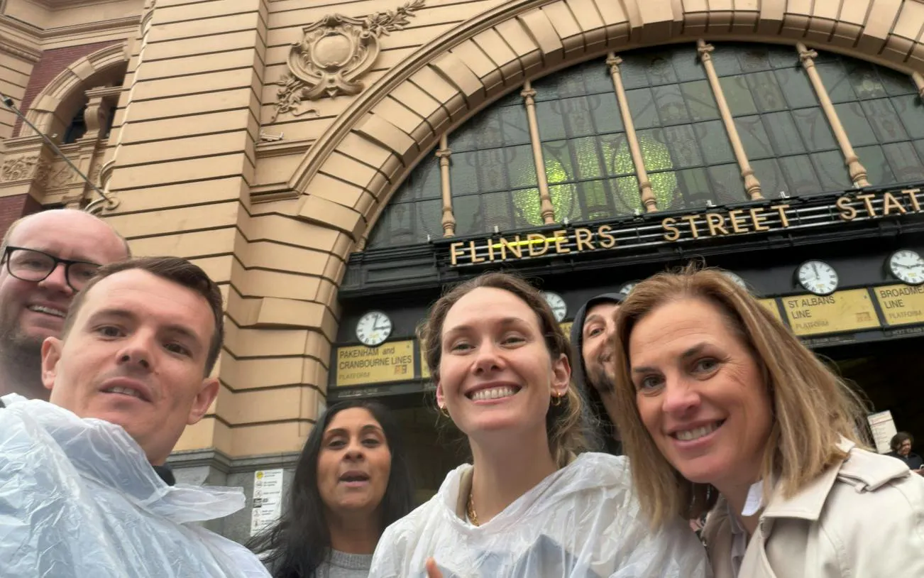 Group at Flinders Street Station entrance, Melbourne, for self-guided city exploration game.