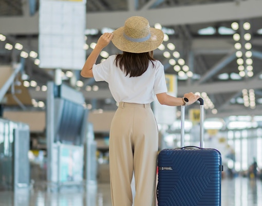 A female tourist walking inside an Airport