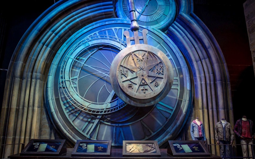 Pendulum at Hogwarts in Warner Bros Studio, London, with intricate clock design.