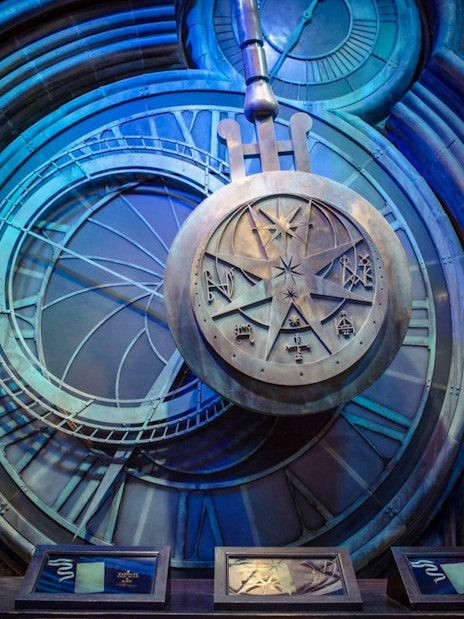 Pendulum at Hogwarts in Warner Bros Studio, London, with intricate clock design.