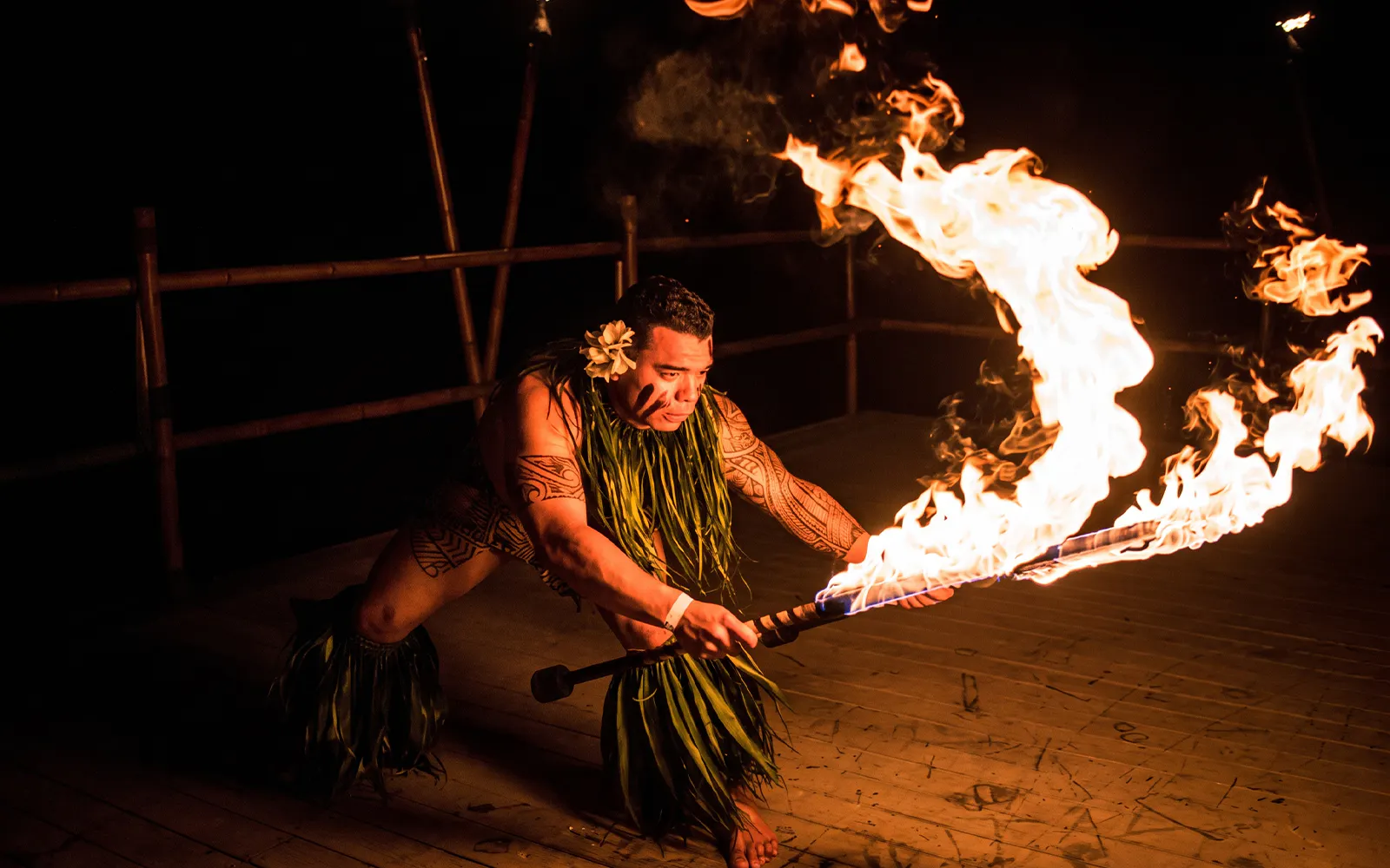 Performer with flaming torch at Voyagers of the Pacific Luau.