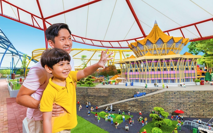 Father and son exploring LEGO Miniland Malaysia at Legoland, featuring iconic landmarks.